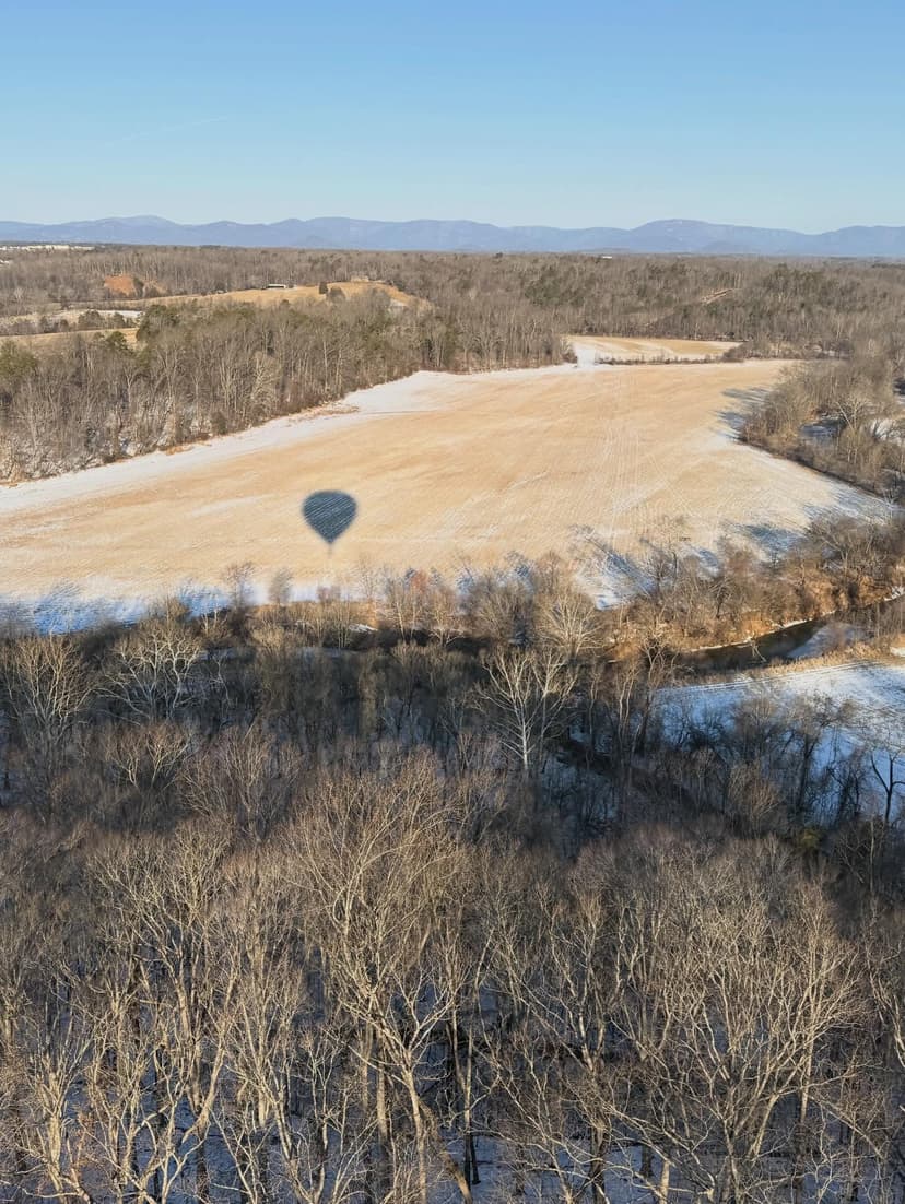Balloon shadow cast on snowy Virginia field — year-round flying